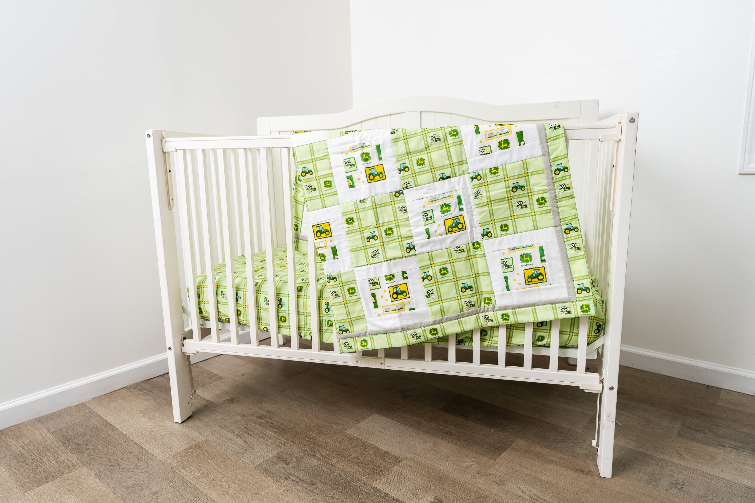 Nursery Set displaying John Deere Tractors and Logos, Green Plaid