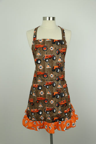 Ladies' Allis Chalmers Apron with Ruffles, Tractors on a Brown Barn Wood Background